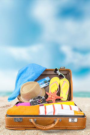 a close up of a suitcase with summer clothing 
