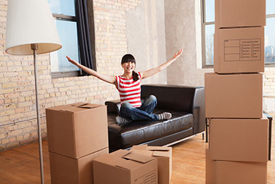 a person siting in a room of moving boxes 
